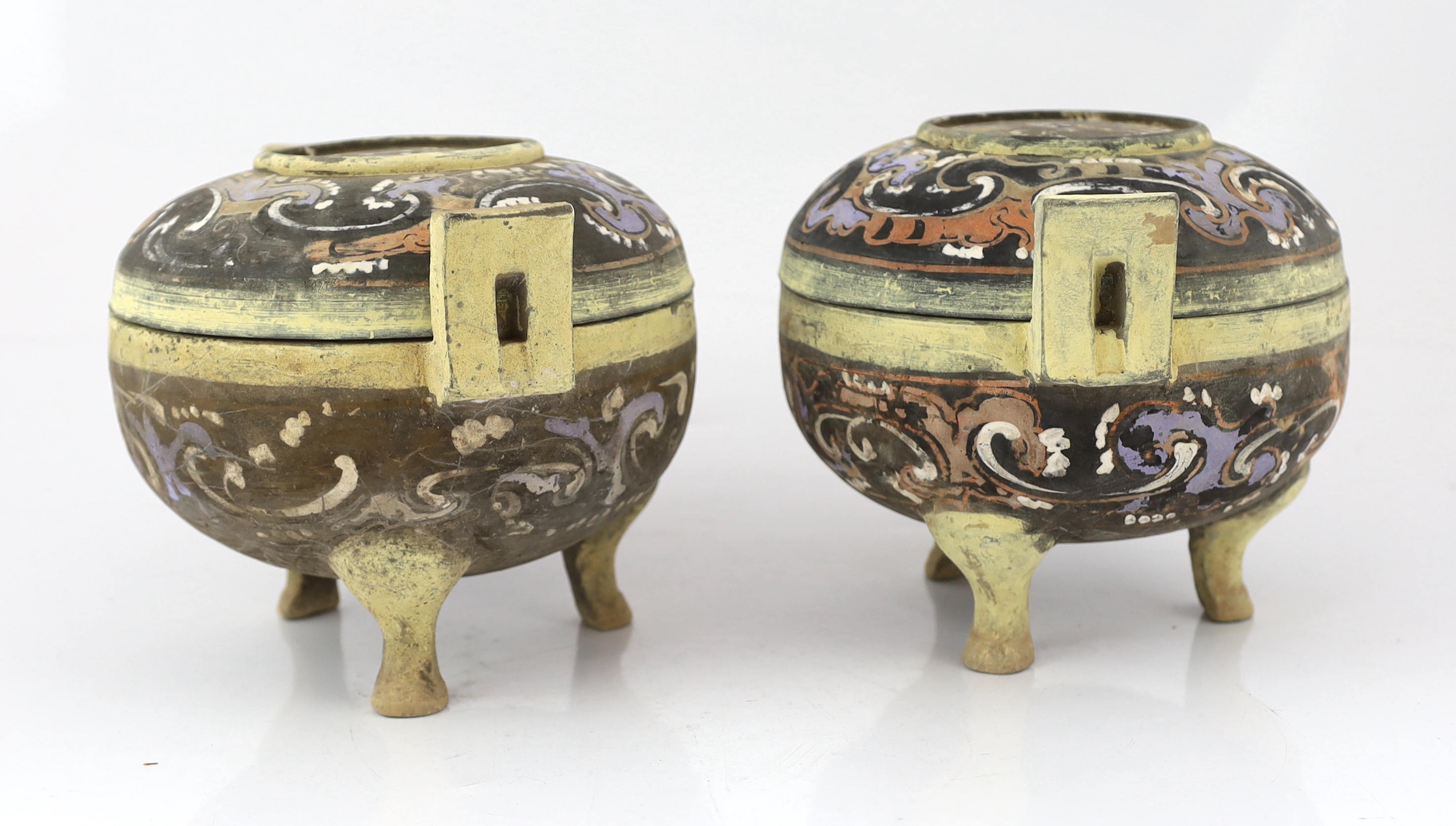 A pair of Chinese polychrome pottery ritual tripod vessels and covers, ding, Han dynasty (202BC - 220AD)